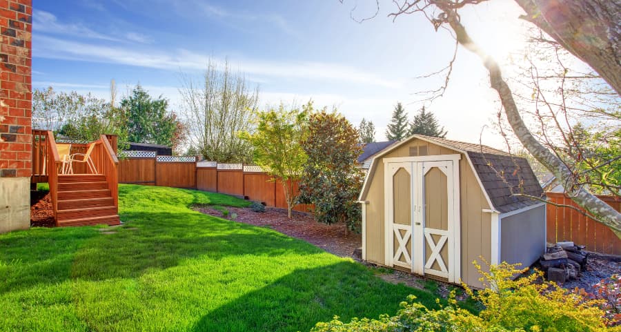 Fenced backyard with storage shed in New Orleans